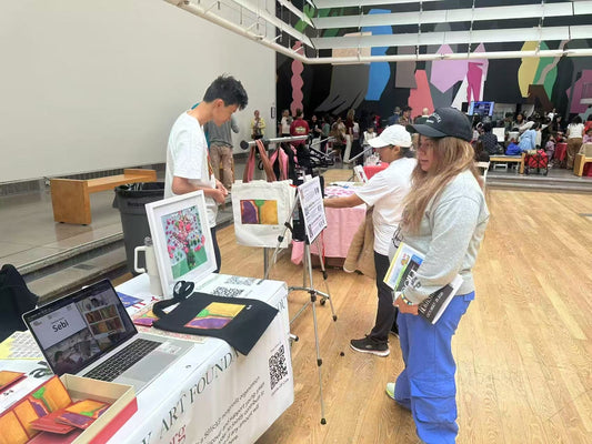 Visitors at the New York Art Foundation for Youth and Initially Shop table at the Queens Museum