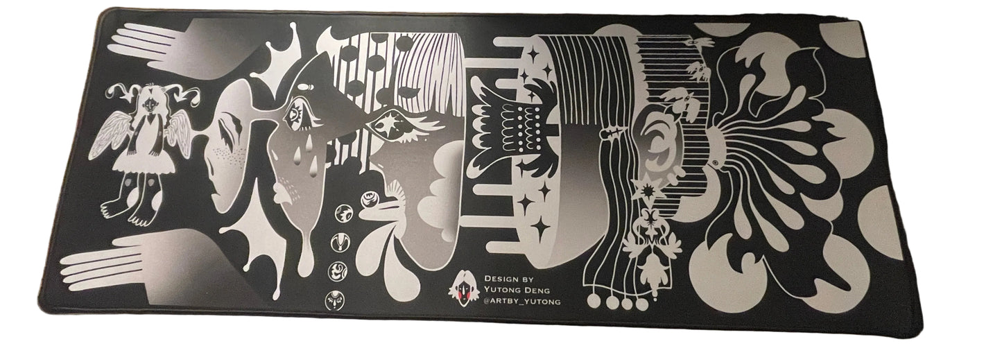 Desk setup with a decorative mouse pad featuring artistic designs.