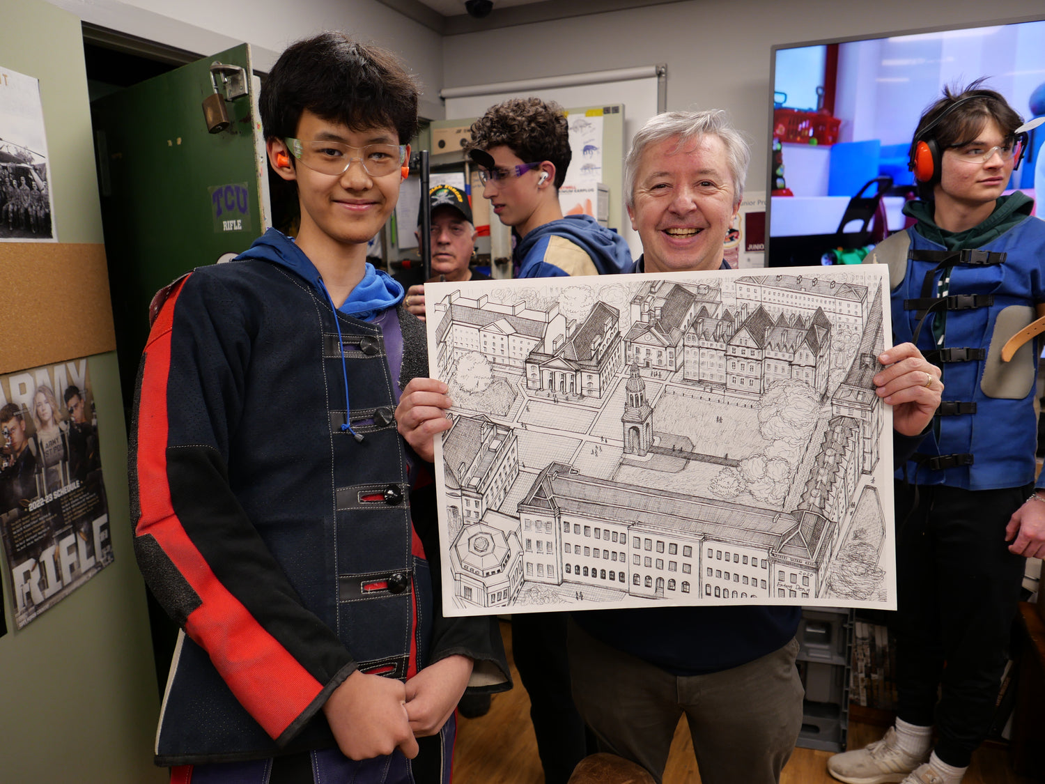 Entong Deng holding his architectural drawing with professor